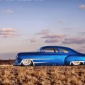 sparkling blue hot rod chevy in the desert