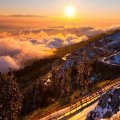 mountain road over foggy valley in sunrise