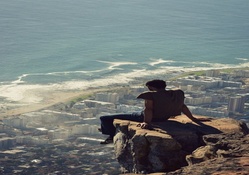 Awesome Picture of a Man Sitting on a Cliff Ledge in Cape Town