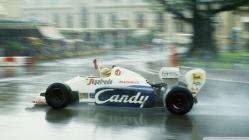 grand prix racing in a rainy city street