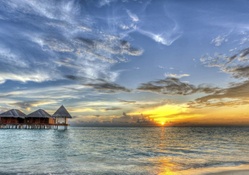 gorgeous stilted bungalows in a maldives sunset hdr