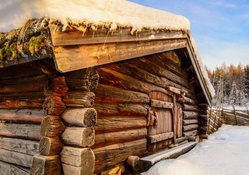 snow covered log cabin