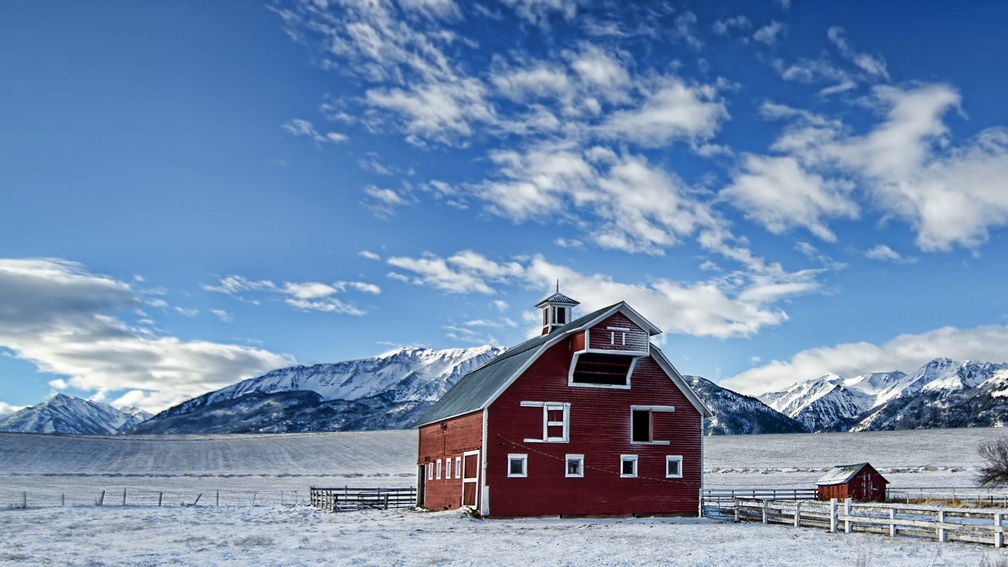beautiful red barn on a farm in winter