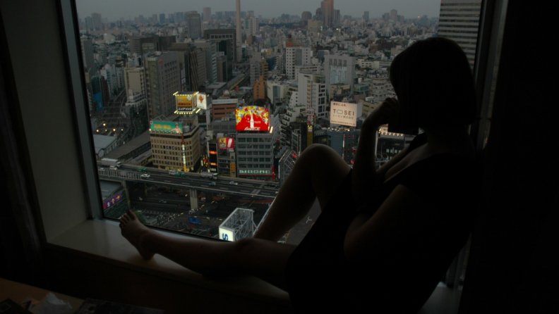 girl looking down on the city of tokyo