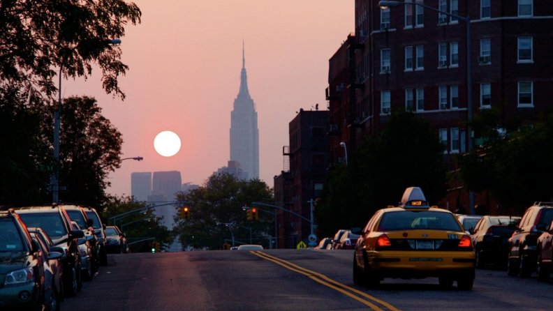empire state building in the distance at sunset