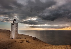 square lighthouse on a sandy seacoast