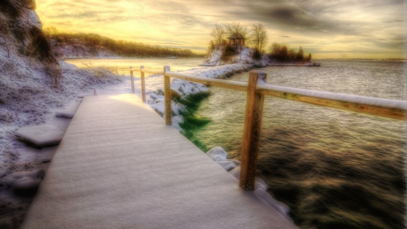 bridge on a wharf to an island on a lake in winter hdr