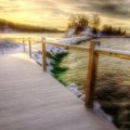 bridge on a wharf to an island on a lake in winter hdr