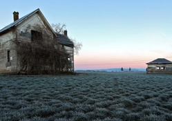 abandoned farmhouse in the middle of fields