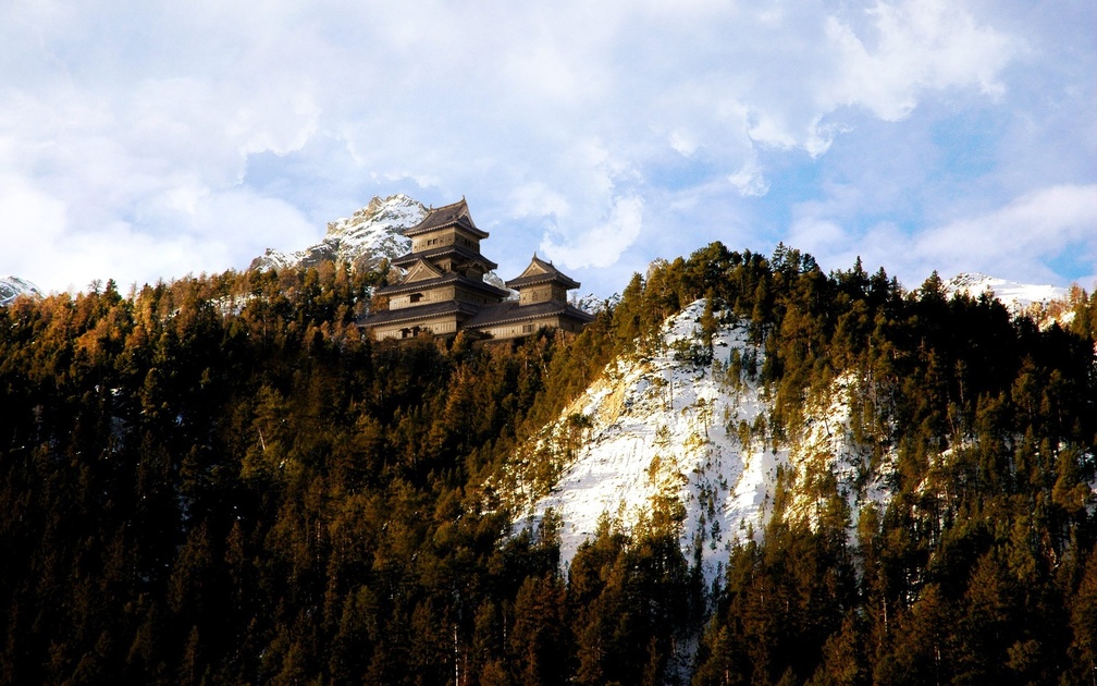 japanese castle on a mountain in winter