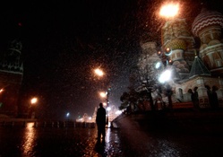 snow shower in red square moscow at night