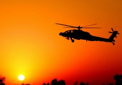combat helicopter at sunset