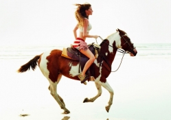 Cowgirl Riding The Beach