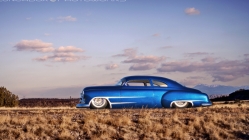 sparkling blue hot rod chevy in the desert