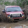 FORD DRIVING DEEP IN THE MUD