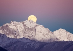 moon rise over majestic mountain