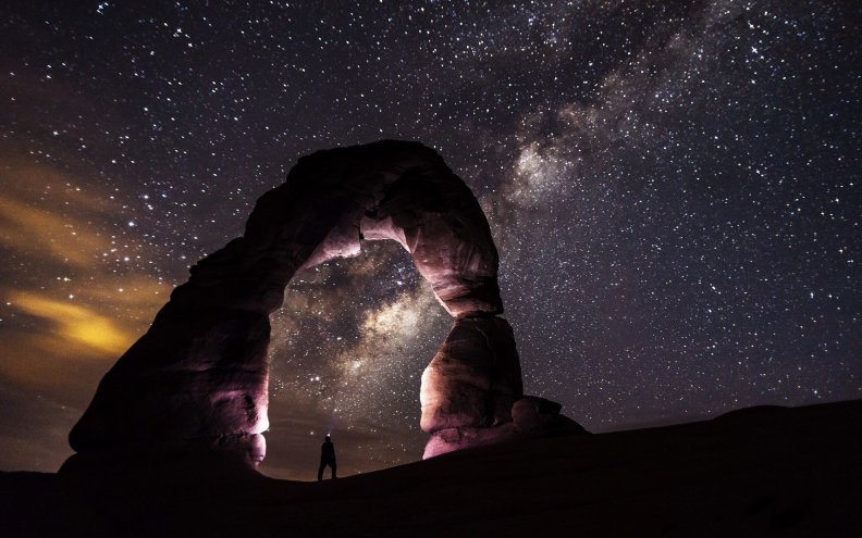 delicate natural arch under starry sky