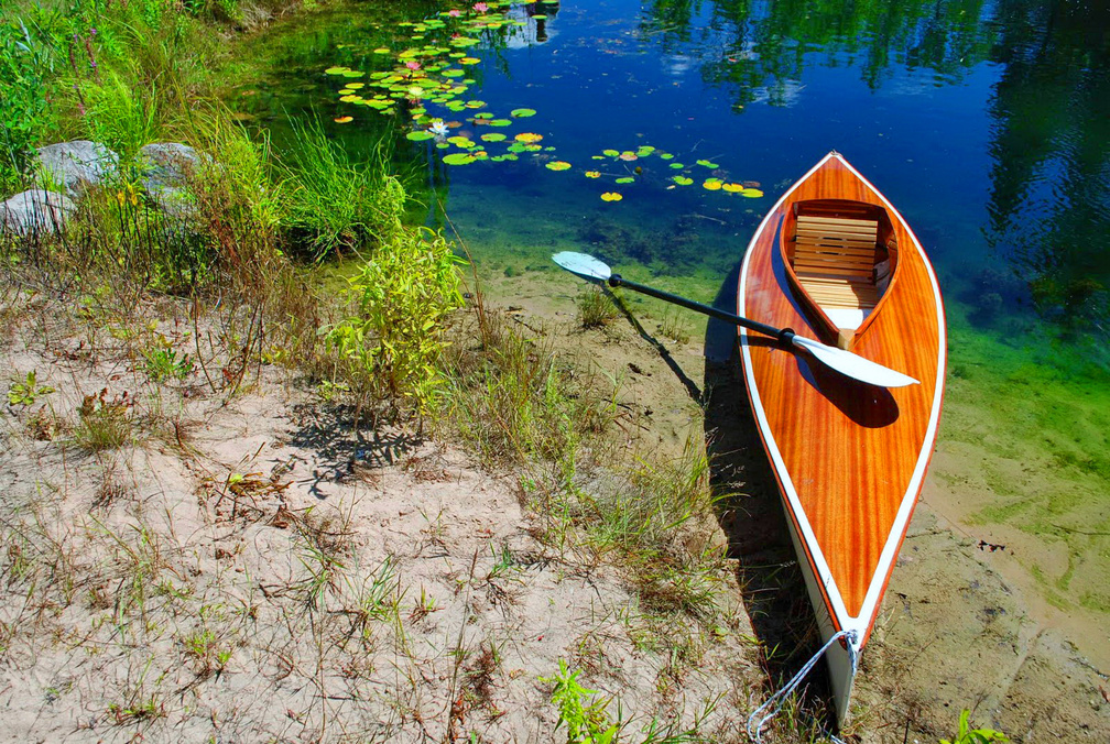Lonely canoe on lakeshore