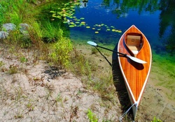 Lonely canoe on lakeshore