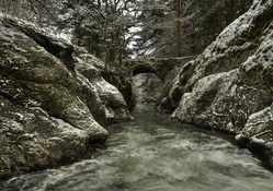 stone bridge over river gorge in winter monochrome 