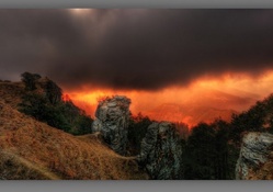 rain clouds over mountains at sunset hdr