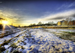 sunset over train track in winter hdr