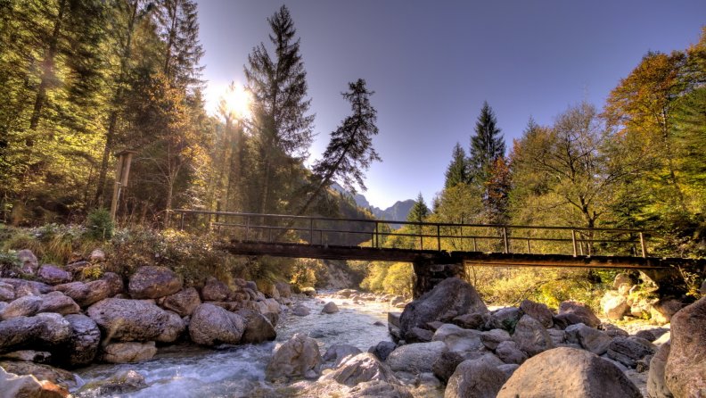 foot bridge over rocky mountain river hdr