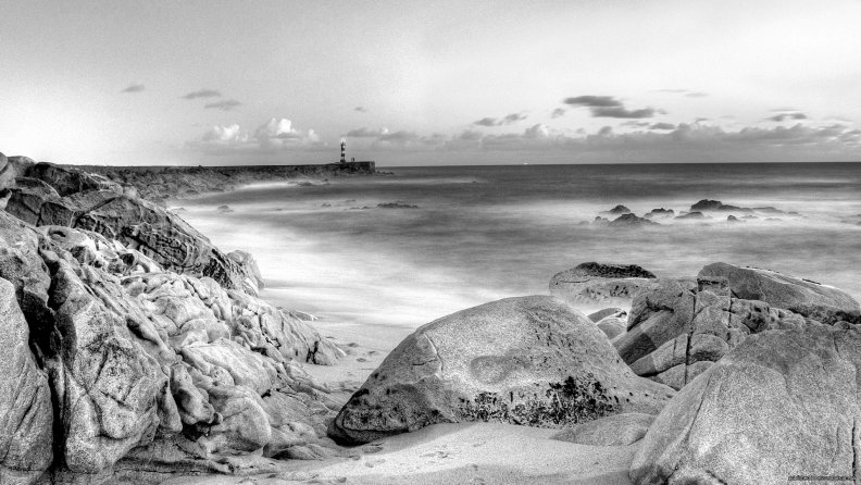 lighthouse_on_a_stone_pier_in_grayscale_hdr.jpg