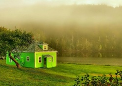 green house on a foggy river bank