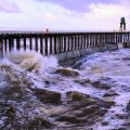stormy sea at a beacon on a wharf