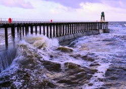 stormy sea at a beacon on a wharf