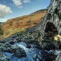 stone bridge over rocky mountain stream hdr