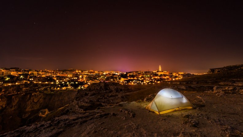 camping_outside_a_desert_city_at_night.jpg
