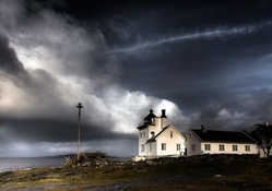 lighthouse under stormy skies