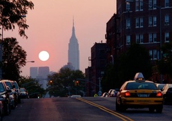 empire state building in the distance at sunset