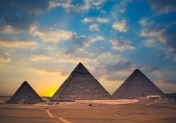 yellow sunrise behind the great pyramids
