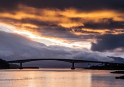 skye bridge in scotland under fiery sky