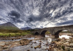 ancient stone bridge on a stone river hdr