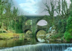 wonderful old bridge over river and waterfall