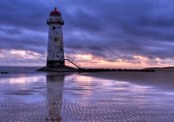 decrepit lovely lighthouse at low tide