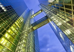 glass skyscraper with a sky bridge