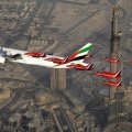 boeing 777 with military escort over burj kahlifa in dubai
