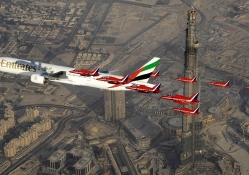 boeing 777 with military escort over burj kahlifa in dubai