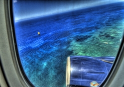 view of ship on an ocean from a plane window hdr