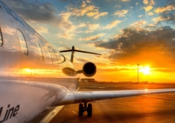 fantastic sunset behind a plane on the tarmac hdr