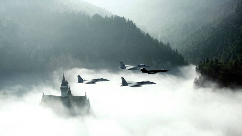 fighter planes over german castle in fog