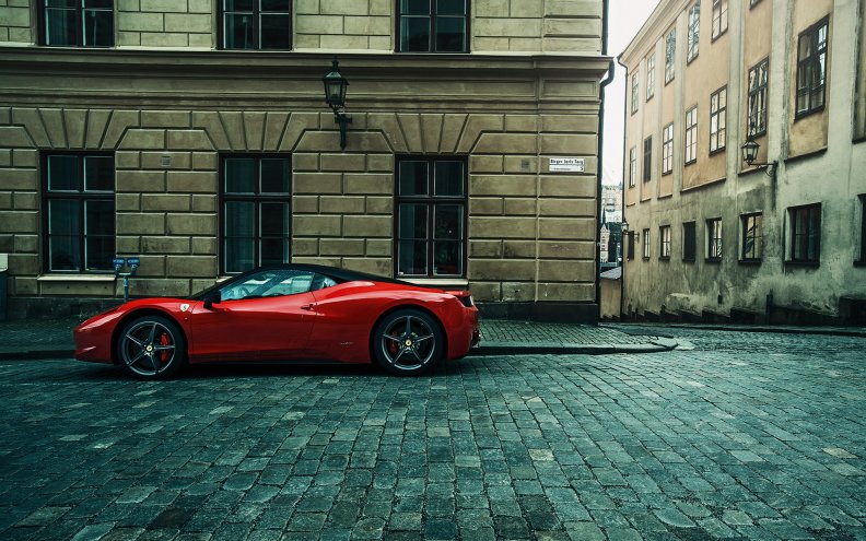 red ferrari parked on a street