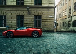 red ferrari parked on a street