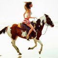 Cowgirl Riding The Beach