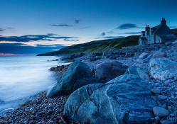 blue grey rocky seashore at twilight